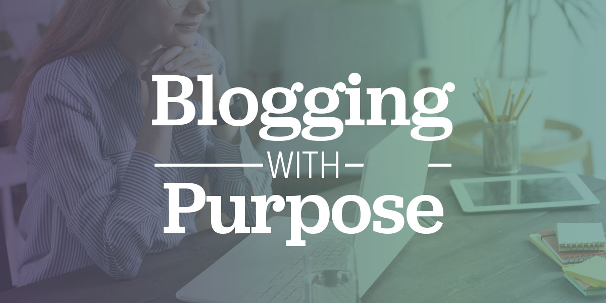 A woman sitting at her desk writing a blog article.