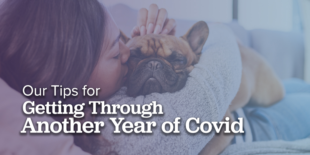 woman cuddling with a french bulldog 